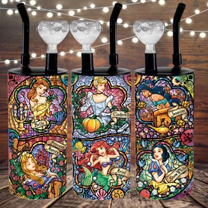 May include: Set of four colorful glass water pipes with Disney Princesses on them. The princesses are Belle, Cinderella, Jasmine, and Snow White. Each pipe has a glass bowl and a black mouthpiece.
