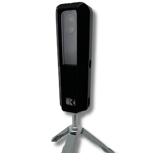May include: A black rectangular device with a camera lens and a small red logo, mounted on a gray tripod. The device has a sleek, modern design, suitable for various applications.