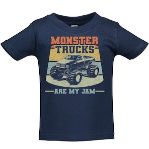 May include: A navy blue toddler t-shirt featuring a vintage-style graphic of a monster truck. The graphic includes the text "Monster Trucks Are My Jam".