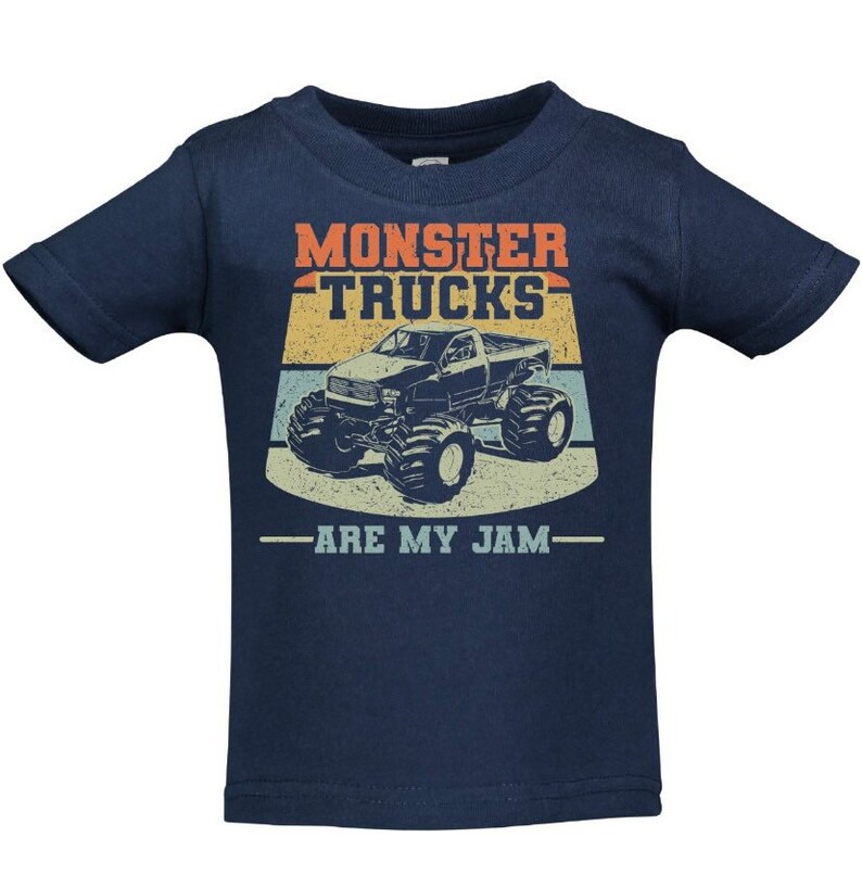 May include: A navy blue toddler t-shirt featuring a vintage-style graphic of a monster truck. The graphic includes the text "Monster Trucks Are My Jam".