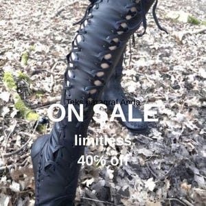 May include: A pair of black knee-high lace-up boots featuring a front-facing lacing system with thin black laces and a rounded toe design. The text ON SALE, limitless, and 40% off is overlaid on the image, along with the text Teks paragraf Anda.