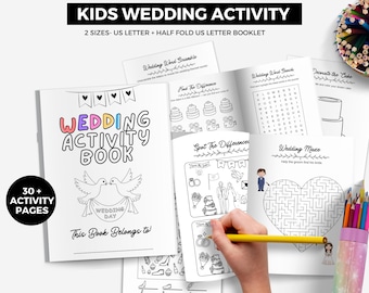 May include: A white wedding activity book for kids with the text "WEDDING ACTIVITY BOOK" in colorful letters. The book includes 30+ activity pages, with word scrambles, mazes, and coloring pages. A hand is holding a yellow pencil.