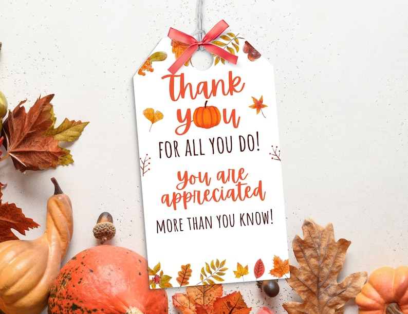 May include: A white gift tag with a red bow and the words "Thank you for all you do! You are appreciated more than you know!" in orange and black. The tag is decorated with fall leaves and a pumpkin.