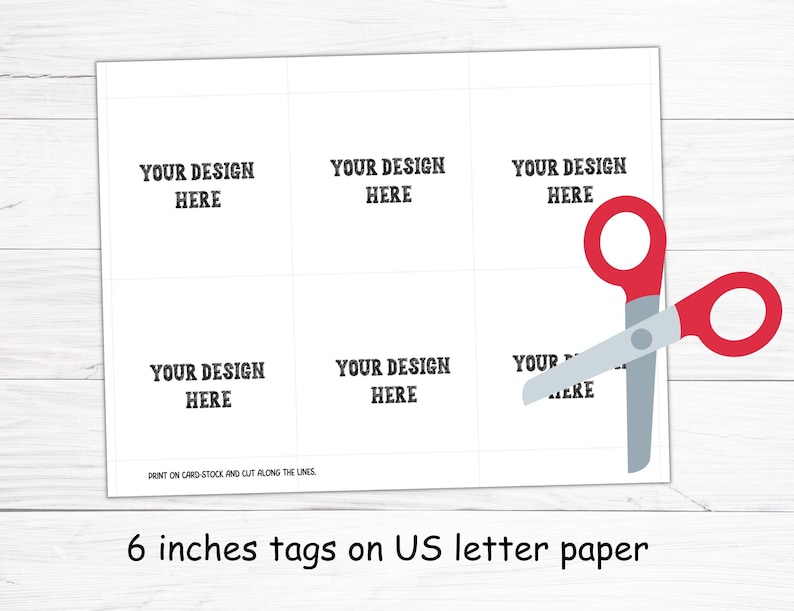 May include: White sheet of paper with six tag templates, each labeled "YOUR DESIGN HERE." Red-handled scissors are positioned to cut the tags. The text at the bottom reads "6 inches tags on US letter paper."