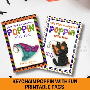 May include: Two Halloween-themed gift tags with the text "Hope Your Halloween is Poppin' With Fun!" One tag features a witch hat-shaped keychain, the other a black cat. The tags have orange, green, and purple accents.