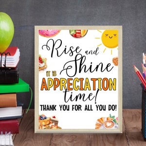 May include: A printable sign with a white background and a wood-like frame. The sign says "Rise and Shine It is Appreciation Time! Thank you for all you do!" with a yellow sun and various breakfast foods around the text.
