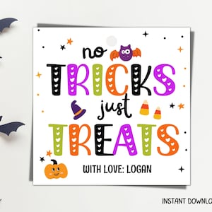 May include: A square white gift tag featuring the text no TRICKS just TREATS in colorful letters with heart patterns. The design includes a small purple bat, a witch hat, candy corn, and an orange pumpkin. The bottom reads WITH LOVE: LOGAN.