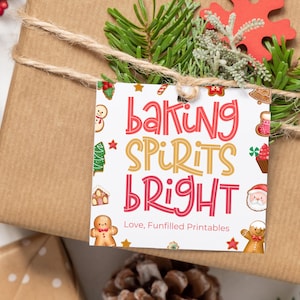 May include: A brown wrapped gift with twine and a decorative tag that reads "Baking Spirits Bright" in red and yellow lettering. The tag is decorated with gingerbread men, a Christmas tree, and a Santa Claus illustration.