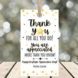 May include: A white tag with gold stars and the text "Thank yu FOR ALL YOU DO! * You are appreciated MORE THAN YOU KNOW! Happy Employee Appreciation Day! FROM: CALEB"