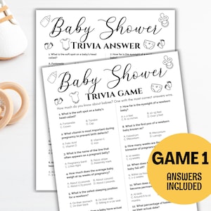 May include: Baby shower trivia game and answer sheets. The black and white sheets have questions about babies. A yellow circle with the text "GAME 1 ANSWERS INCLUDED" is on the right. Baby shoes and a wooden toy are in the background.
