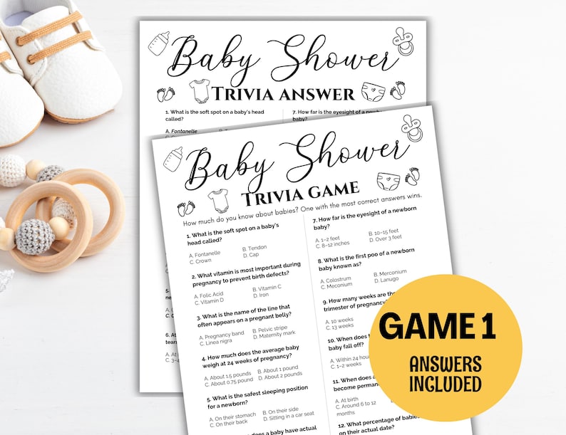 May include: Baby shower trivia game and answer sheets. The black and white sheets have questions about babies. A yellow circle with the text "GAME 1 ANSWERS INCLUDED" is on the right. Baby shoes and a wooden toy are in the background.