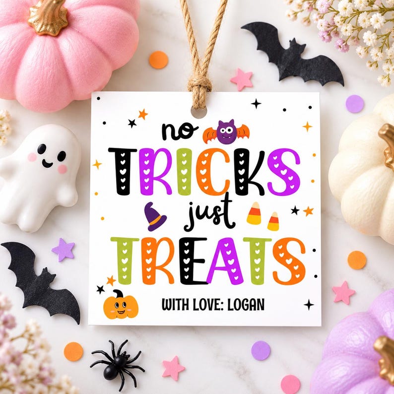 May include: A square white gift tag with a jute twine loop featuring the text "no TRICKS just TREATS" in colorful, patterned letters. The design includes a purple bat, a witch hat, candy corn, a small orange pumpkin, and "WITH LOVE: LOGAN".