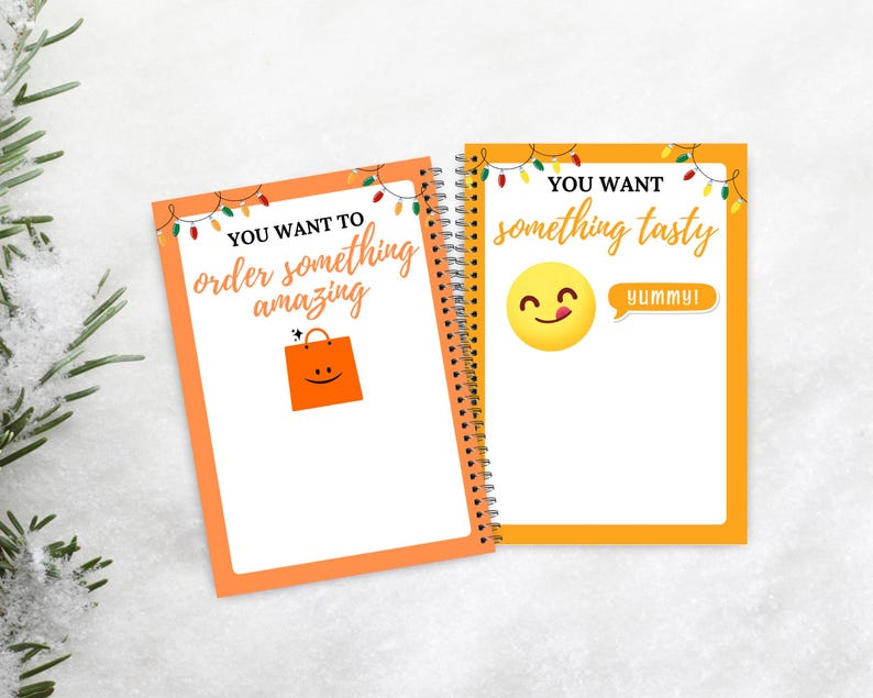 Puede incluir: Dos cuadernos con espiral con bordes naranjas y p&aacute;ginas blancas. Uno tiene el texto "YOU WANT TO order something amazing" y un gr&aacute;fico de bolsa de la compra. El otro dice "YOU WANT something tasty" con una carita sonriente y "YUMMY!"