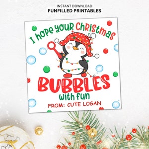 May include: A square printable featuring a cartoon penguin wearing a red and white hat and string lights, blowing bubbles. The text reads "I hope your Christmas bubbles with fun" and "From: Cute Logan."