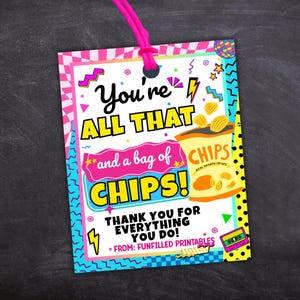 May include: A colorful gift tag with the text "You're ALL THAT and a bag of CHIPS!" and a bag of chips illustration. The tag has a pink string and a retro design with a black background.