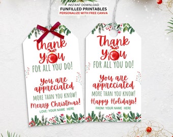 May include: Two white Christmas gift tags with red text that reads "Thank You". One tag has a red bow. The tags have a festive design with greenery and a red ornament. The tags say "Merry Christmas!" and "Happy Holidays!"