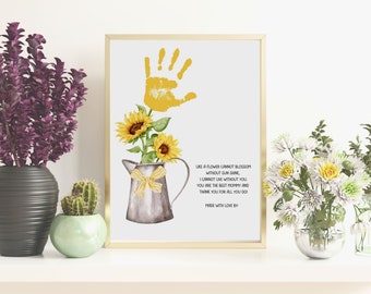 May include: A watercolour print featuring a yellow handprint, sunflowers, and a metal pitcher with a yellow bow. The print includes the text "Like a flower cannot blossom without sun shine, I cannot live without you. You are the best mommy and thank you for all you do. Made with love by."
