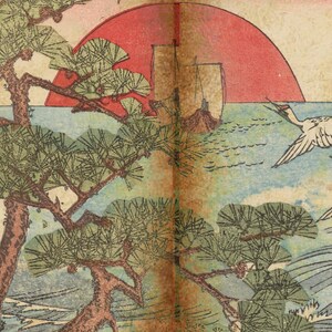 May include: A traditional Japanese woodblock print depicting a red sun setting over a body of water. Two white cranes fly in the sky above a pine tree and a boat. The print is in shades of blue, green, red, and brown.