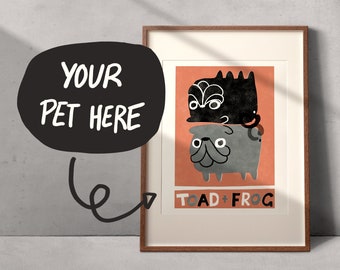 May include: Framed art print featuring a whimsical illustration of two stacked cartoon animals, one black and one gray, on an orange background. The text "TOAD + FROG" is at the bottom. A black speech bubble with the text "YOUR PET HERE" is on the left.