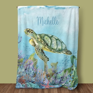 May include: A watercolor illustration of a sea turtle swimming in the ocean with coral reefs and fish. The name "Michelle" is written in cursive at the top of the image.