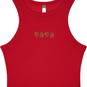 May include: A red crop top with a scoop neck and embroidered strawberry design. The strawberries are pink, orange, and green. The top is sleeveless and made of a soft material.