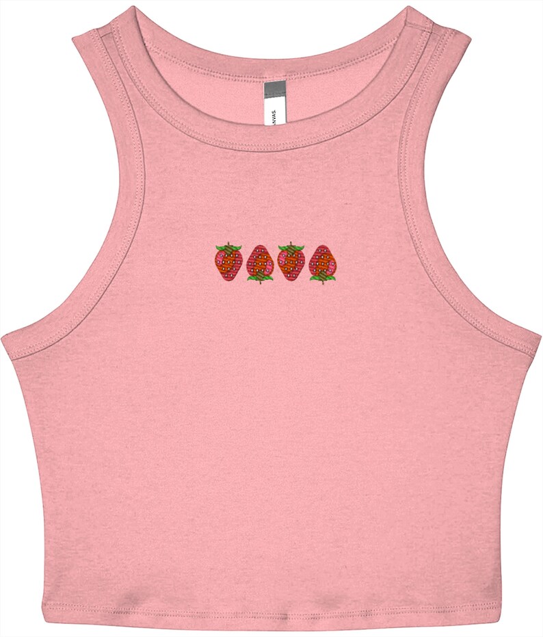 May include: A light pink crop top with a scoop neck and a row of four embroidered strawberries across the chest. The strawberries are red with green leaves. The top is sleeveless.