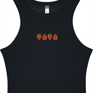 May include: Black crop top with a scoop neck and embroidered strawberries. The strawberries are red with green leaves and are embroidered in a row across the chest. The top is sleeveless and made of a soft material.