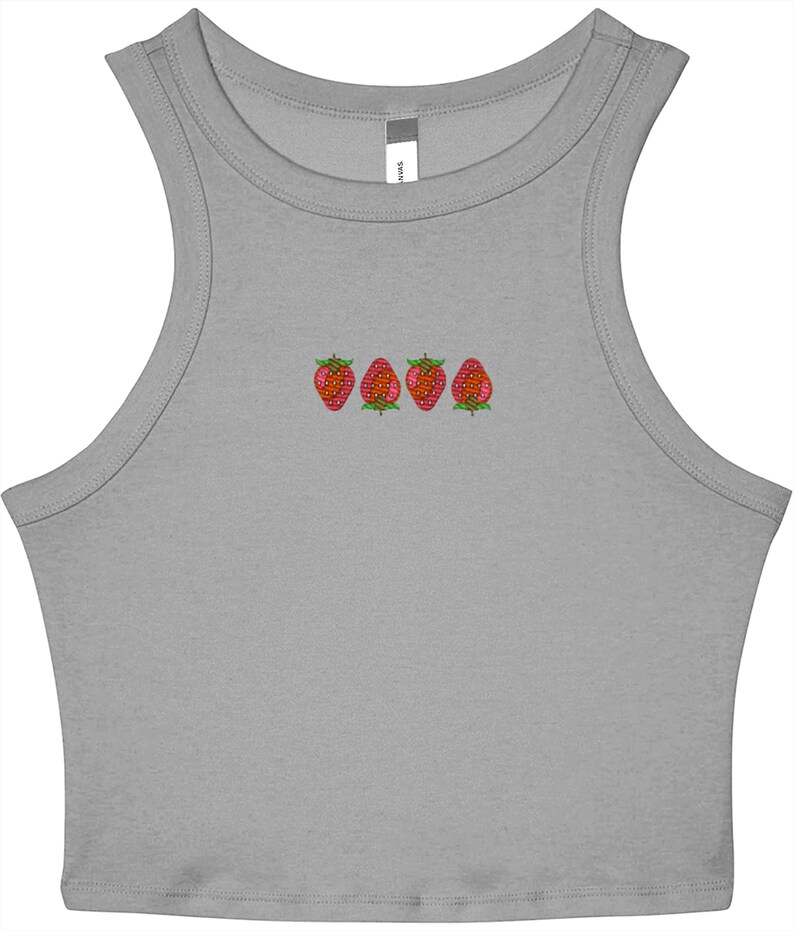 May include: A gray crop top with a scoop neck and embroidered strawberries. The strawberries are red with green leaves and are arranged in a horizontal line across the chest.