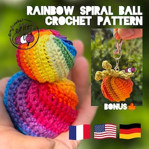 May include: A crochet pattern titled RAINBOW SPIRAL BALL CROCHET PATTERN featuring a multi-colored yarn sphere with a spiral design. A bonus section shows an orange crocheted pumpkin keychain with a metal clasp and green leaf accents.