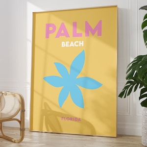 Palm beach florida text in pink and white on a yellow background with a blue flower illustration