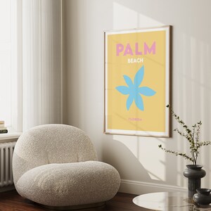 Palm beach florida text in pink and white on a yellow background with a blue flower illustration