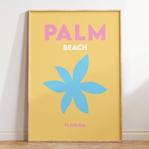 Palm beach florida text in pink and white on a yellow background with a blue flower illustration