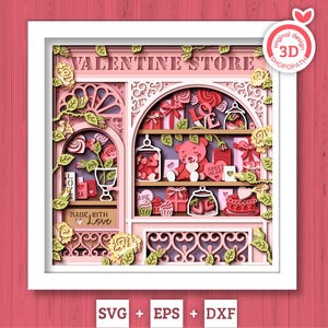 May include: A layered paper art piece of a Valentine's Day store, featuring shelves with gifts, a teddy bear, and sweets. The design includes the text "VALENTINE STORE" and "MADE WITH LOVE". The color palette is soft pinks, reds, and greens.