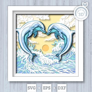 May include: A multi-layered paper craft art piece in a white frame featuring two light blue dolphins leaping from ocean waves to form a heart shape against a yellow sun and white clouds. The text SVG + EPS + DXF appears at the bottom.