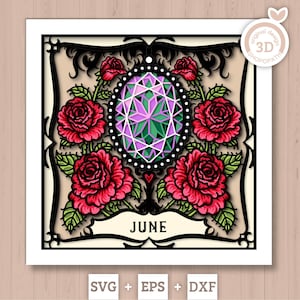 May include: A decorative paper cut design featuring a central geometric gem in shades of purple and green, surrounded by red roses with green leaves. The word "JUNE" is displayed at the bottom. The design is framed with black filigree.