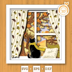 May include: A multi-layered paper craft art piece in a white frame depicting a black cat wearing a yellow scarf sitting by a window. The scene shows autumn trees with orange and yellow leaves, white curtains with leaf patterns, and a white pillow.