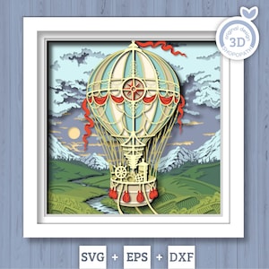 May include: A multi-layered paper craft art piece in a white frame featuring a cream and light blue hot air balloon with red accents, floating over a green landscape with a river, mountains, and a sun, with text reading 3D SHOPOPATH.