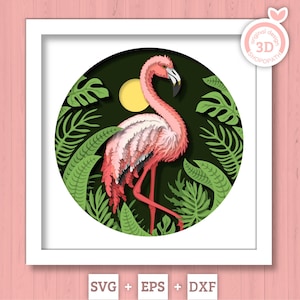 May include: A framed 3D paper art piece featuring a pink flamingo in a tropical setting. The flamingo is surrounded by green leaves and a yellow sun against a dark green background. The artwork is in a white frame.