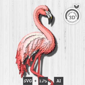 May include: A layered paper flamingo sculpture in shades of pink, red, and white, with a yellow beak and black accents. The artwork is set against a white wood-grain background. Includes the text "SVG + EPS + AI" and a logo that says "original design 3D SHOPOPATH".