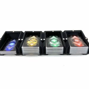 May include: Black card holder with four compartments for organizing cards. Each compartment has a different colored card with the word "ITEM" and a symbol on it. The symbols are a gear, a plus sign, a lightning bolt, and a skull.