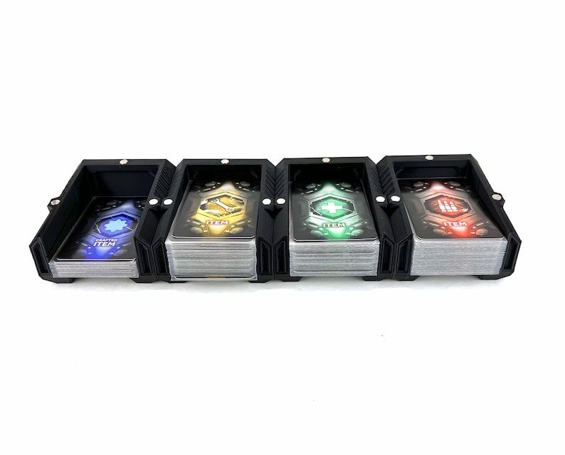 May include: Black card holder with four compartments for organizing cards. Each compartment has a different colored card with the word "ITEM" and a symbol on it. The symbols are a gear, a plus sign, a lightning bolt, and a skull.