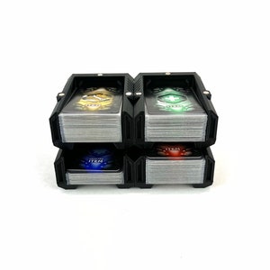 May include: Black card holder with four compartments, each holding a stack of cards with different colored designs. The top card in each compartment has the word "ITEM" printed on it.