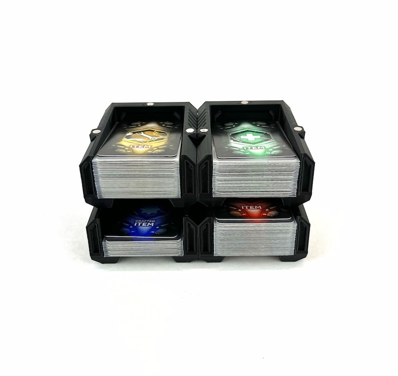 May include: Black card holder with four compartments, each holding a stack of cards with different colored designs. The top card in each compartment has the word "ITEM" printed on it.