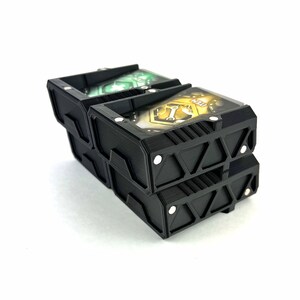 May include: Three black plastic card holders with magnetic closures. The top holder has a green and white card inside, the middle holder has a yellow and black card inside, and the bottom holder is empty.