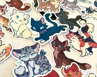 May include: A collection of die-cut vinyl stickers featuring various illustrated cats in diverse poses and colors, including a dark blue cat with a purple collar, a white cat, a grey tabby, and a calico cat, all with stylized, expressive features.