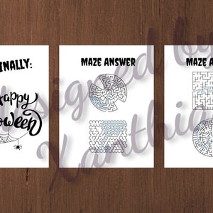 May include: Three white cards with Halloween-themed designs. The first card says "AND FINALLY: Happy Halloween" with a spider web and spider. The other two cards have maze answers.