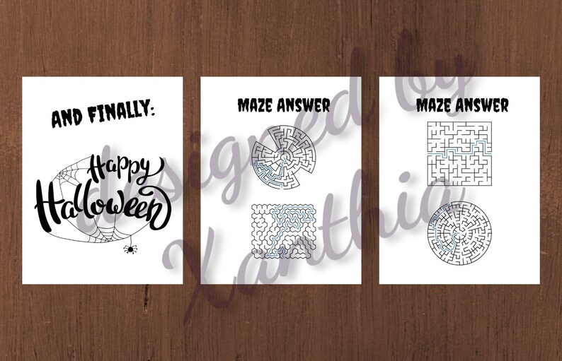 May include: Three white cards with Halloween-themed designs. The first card says "AND FINALLY: Happy Halloween" with a spider web and spider. The other two cards have maze answers.