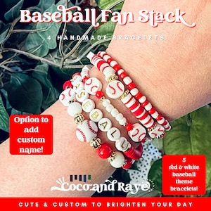 May include: A stack of five red, white, and gold baseball-themed bracelets. The bracelets feature baseball beads, letter beads spelling "BASEBALL", and red and white beads. The image includes text that says "Baseball Fan Stack" and "Option to add custom name!"