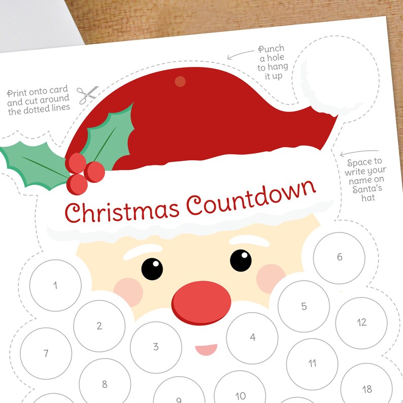 May include: A printable Christmas Countdown featuring Santa Claus. The design includes a red Santa hat, a white beard, and a series of numbered circles for marking the days. The text "Christmas Countdown" is prominently displayed.