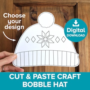 May include: A printable black and white outline of a winter beanie hat with a pom pom on top. The hat has a snowflake and diamond pattern on the front. The text "CUT & PASTE CRAFT BOBBLE HAT" is at the bottom of the image.